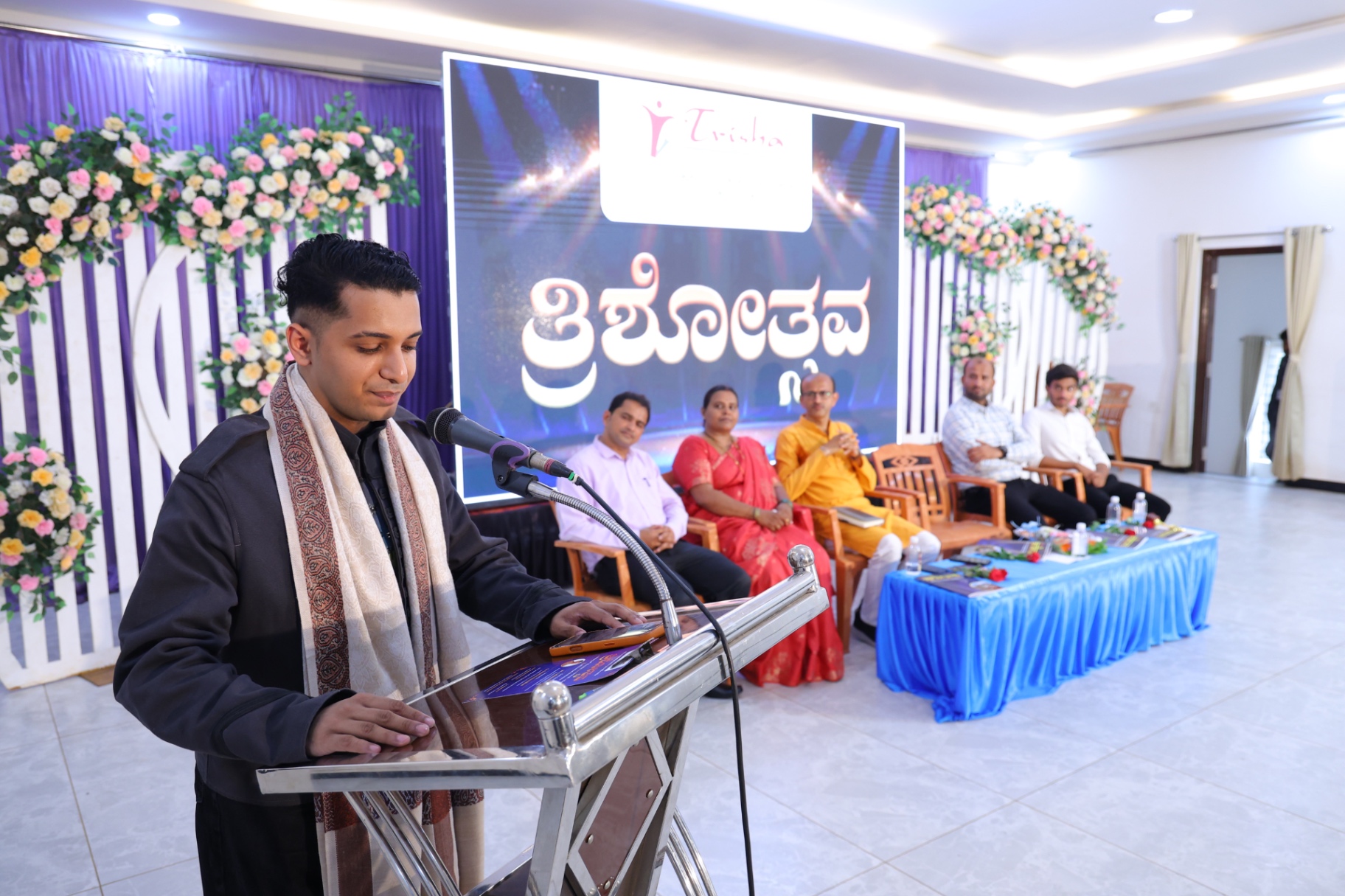 Yudister Narayan speaking at an event podium