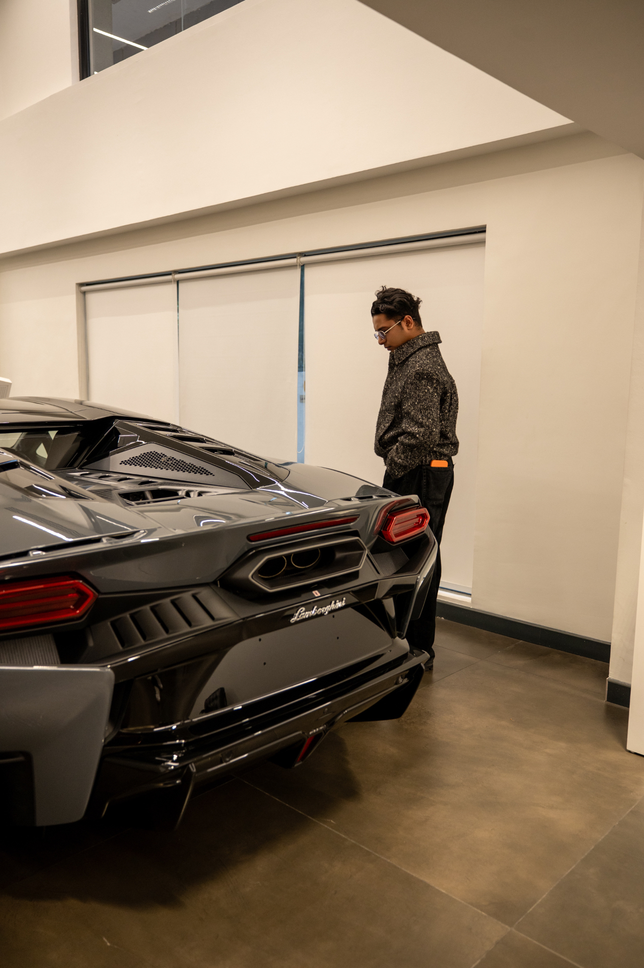 Yudister Narayan beside a Lamborghini